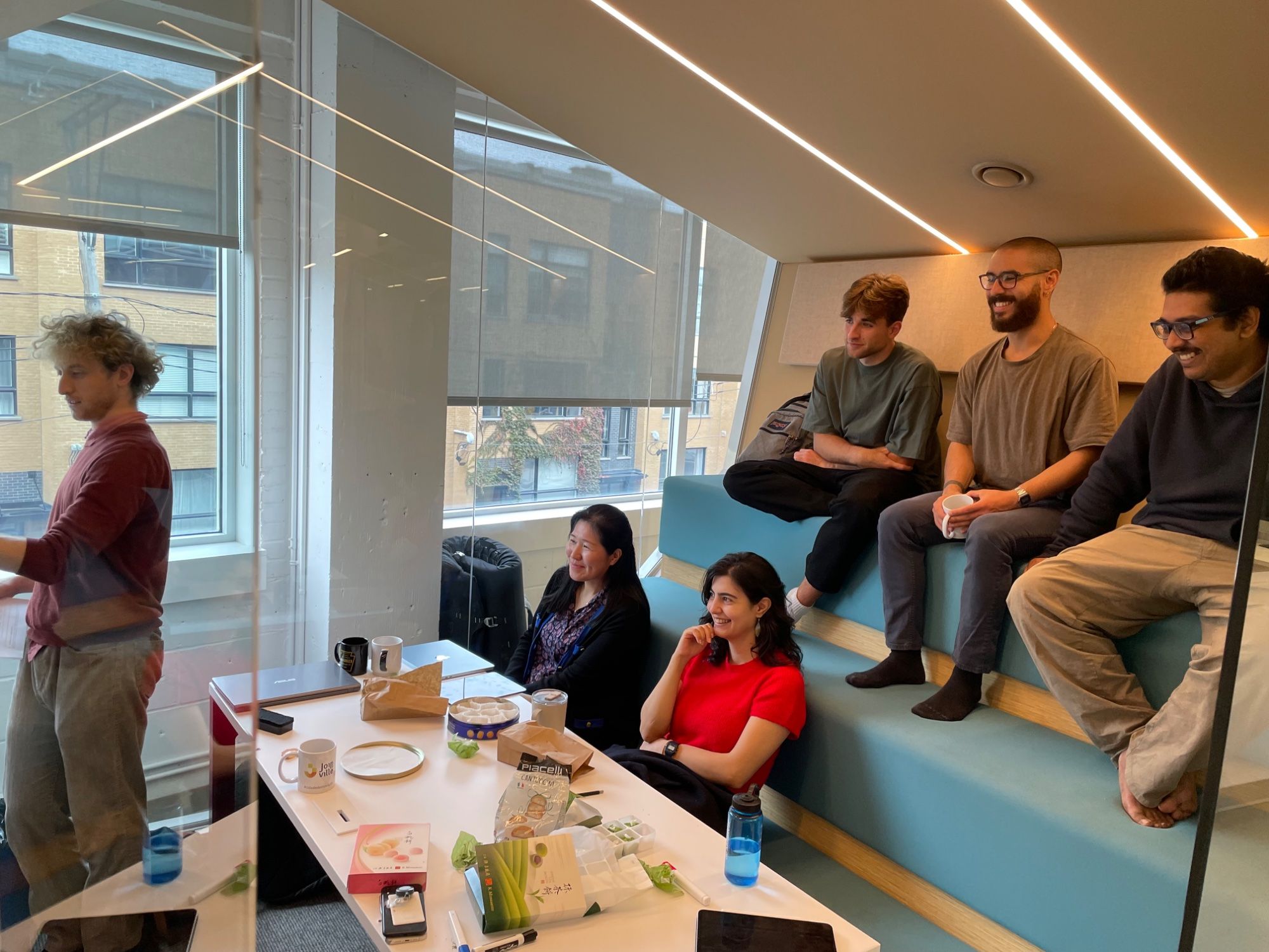 Discussing research at Mila with group members, colleagues and visitors